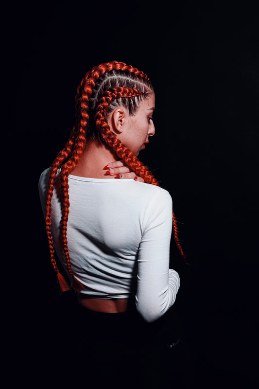 a woman with long red braids in her hair