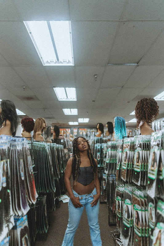 woman in black and white polka dot tank top standing in front of clothes display