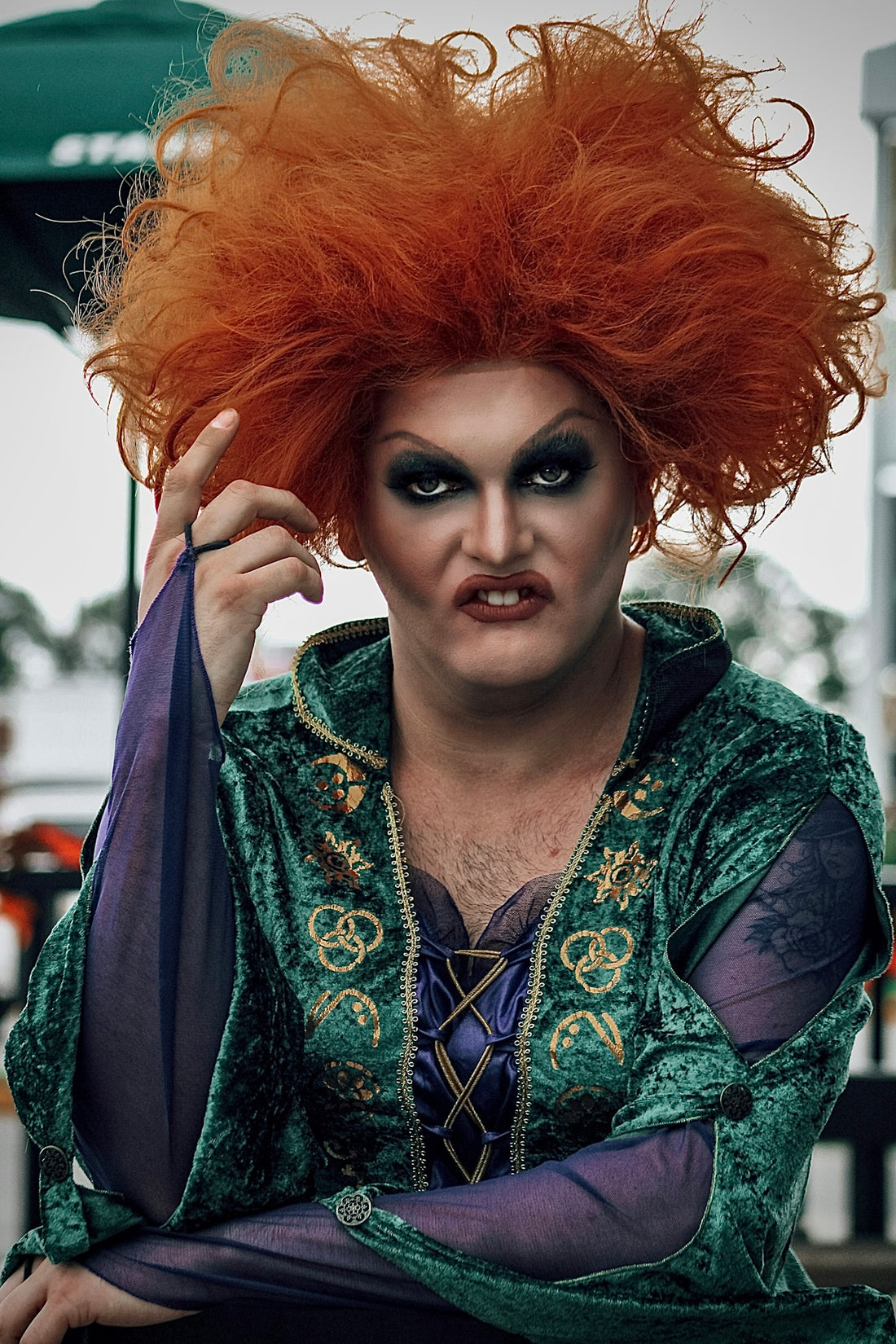 a man with red hair wearing a costume