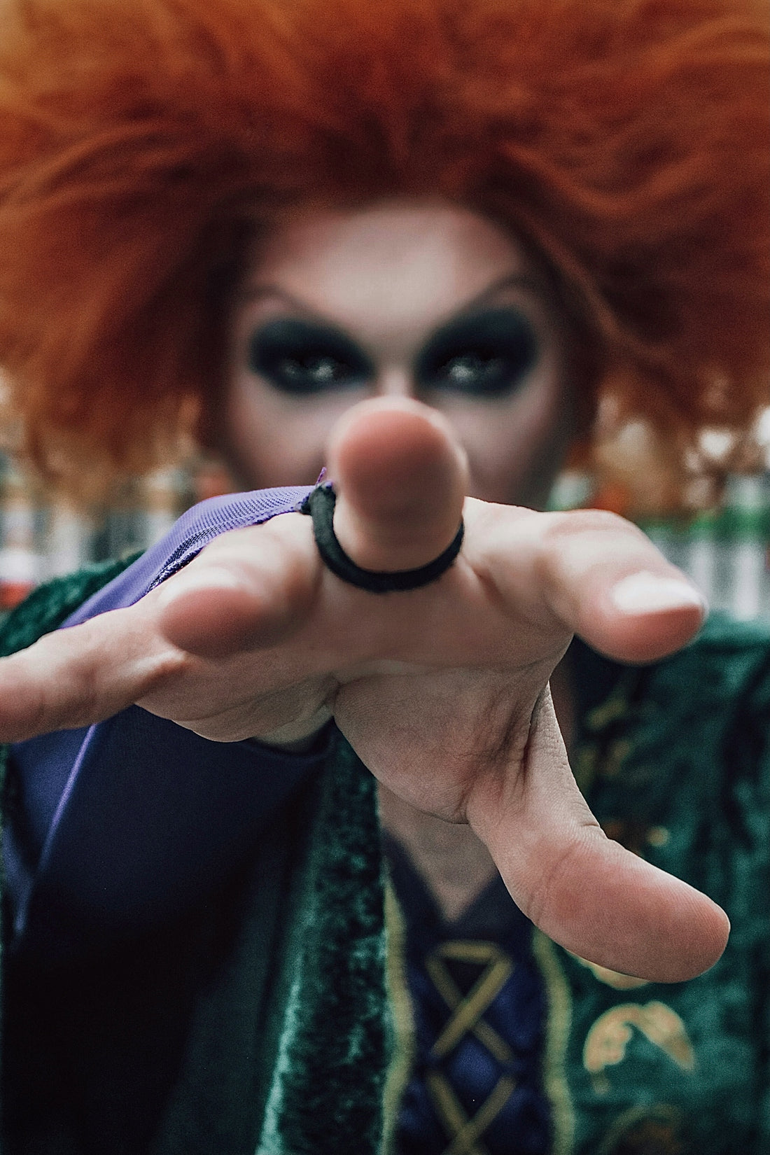 a person with red hair making a hand gesture