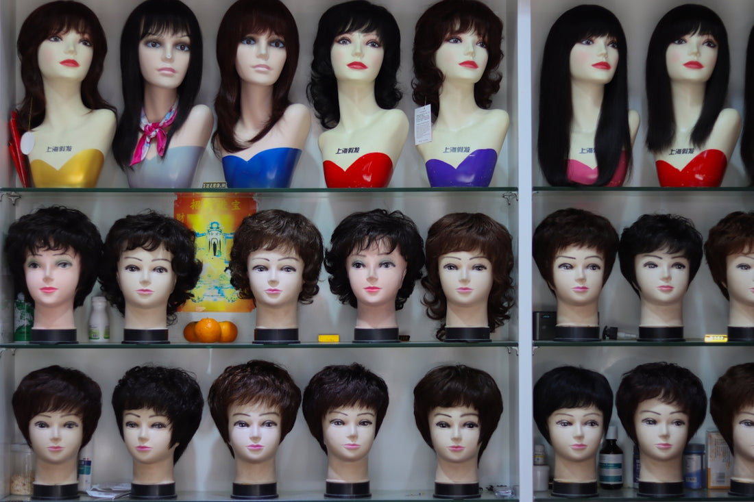 a display case filled with lots of mannequin heads