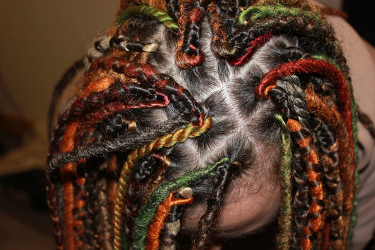 a close up of a person with dreadlocks in their hair