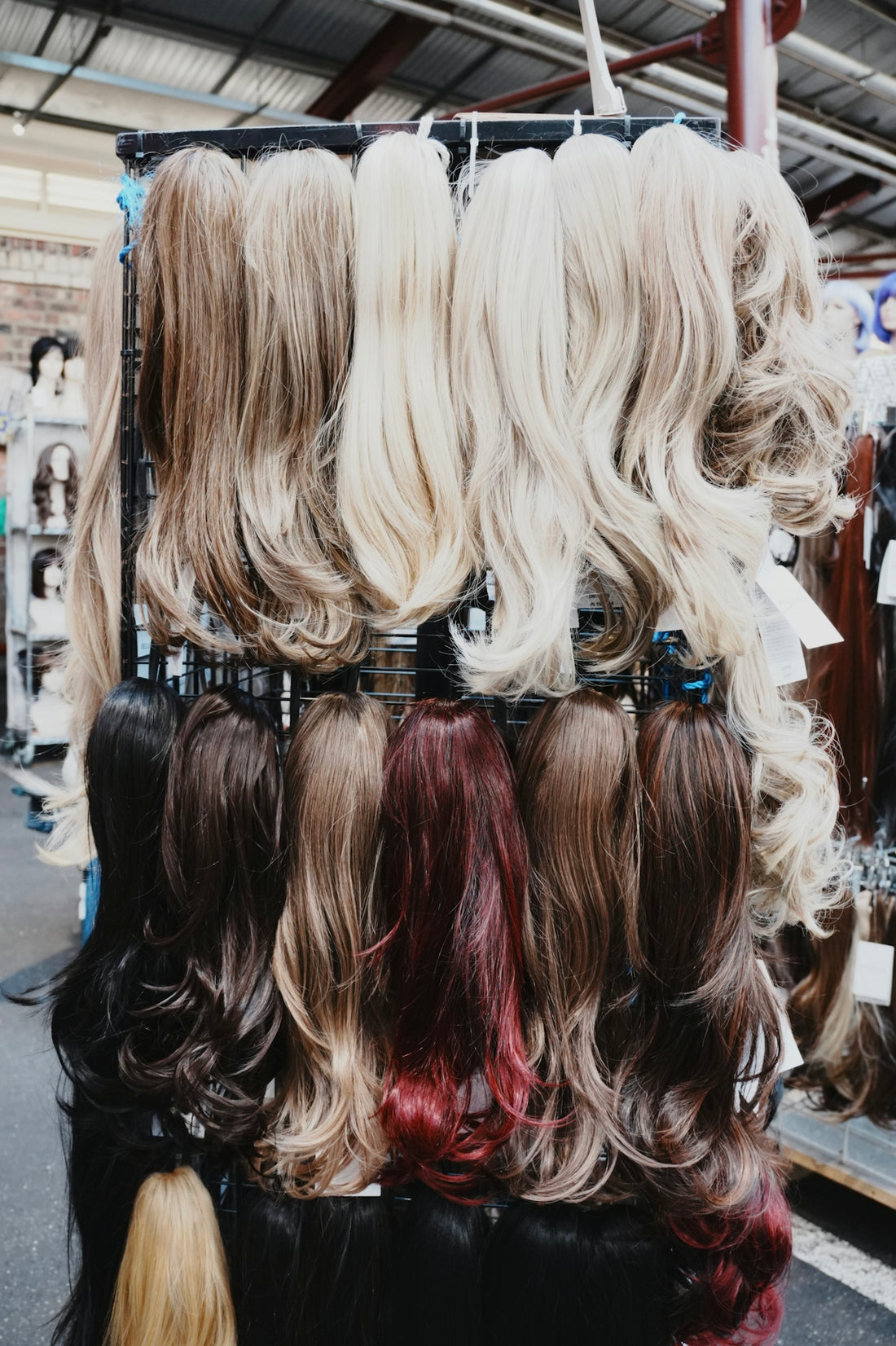 Wigs of various colors are displayed.