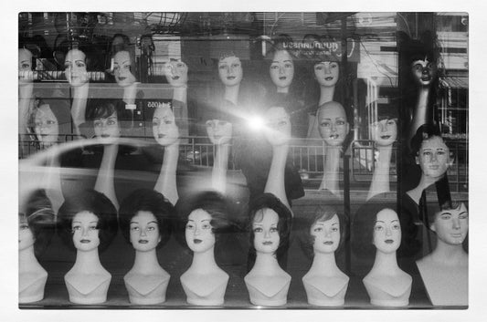 Mannequin heads displayed in a shop window