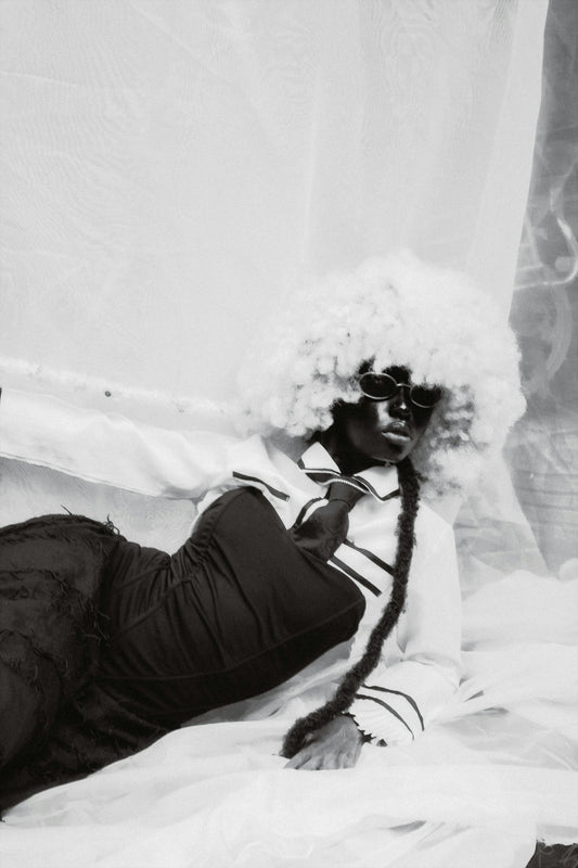Woman with afro wig and sunglasses