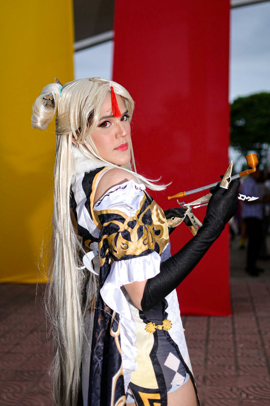 Woman in elaborate costume holding a prop
