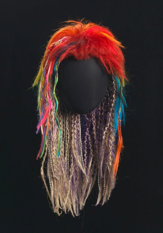 Colorful, multi-textured wig on black background
